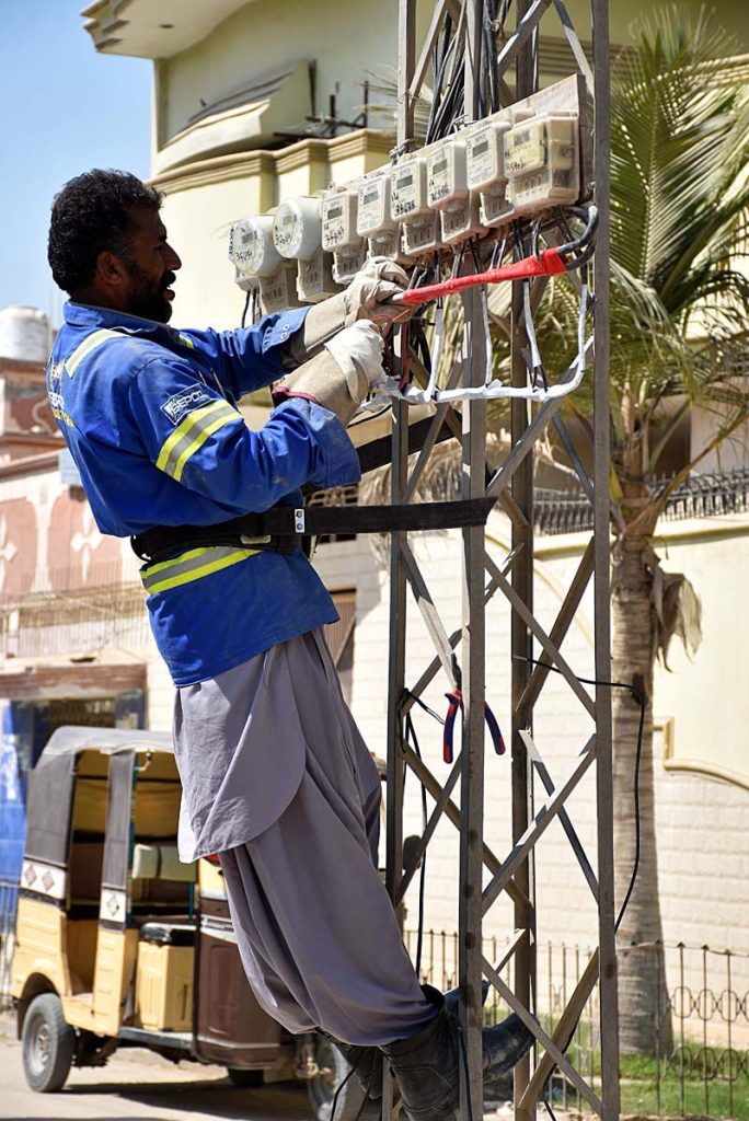 <em>A WAPDA staffer Busy in repairing electric meters at Sachal Colony</em>