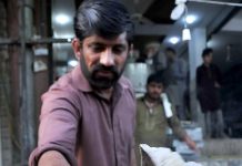 A vendor busy in preparing traditional food item (jalebi) to attract the customers during Holy fasting month of Ramazan