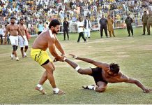 Players of Pakistan White and Pakistan Green Kabaddi teams in action in a Kabaddi Takra at Iqbal Stadium in connection with Jashan-e-Baharan celebrations organized by the district administration