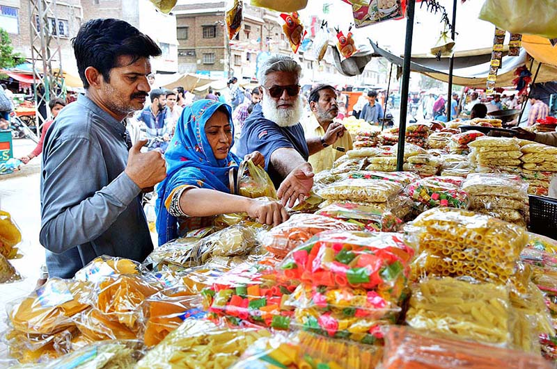 People busy in purchasing food items from vendor during Holy Fasting Month of Ramzan at Tower Market