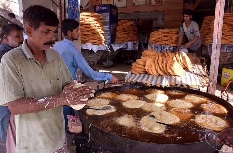 Workers busy in preparing vermicelli (Pheoni) during Holy fasting month of Ramazan at his workplace