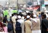 People standing in queue for getting free flour bags under Ramzan Package at Dhoke Khabba.