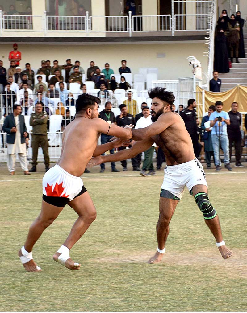 Players of Pakistan White and Pakistan Green Kabaddi teams in action in a Kabaddi Takra at Iqbal Stadium in connection with Jashan-e-Baharan celebrations organized by the district administration