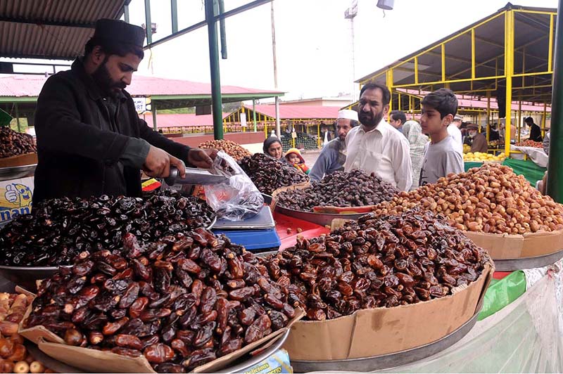 A vendor selling dates during holy fasting month at sasta Ramzan Bazar Abpara in the Federal Capital