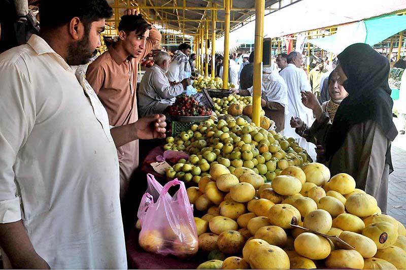 People purchasing watermelon during holy fasting month of Ramazan at sasta bazar in the Federal Capital