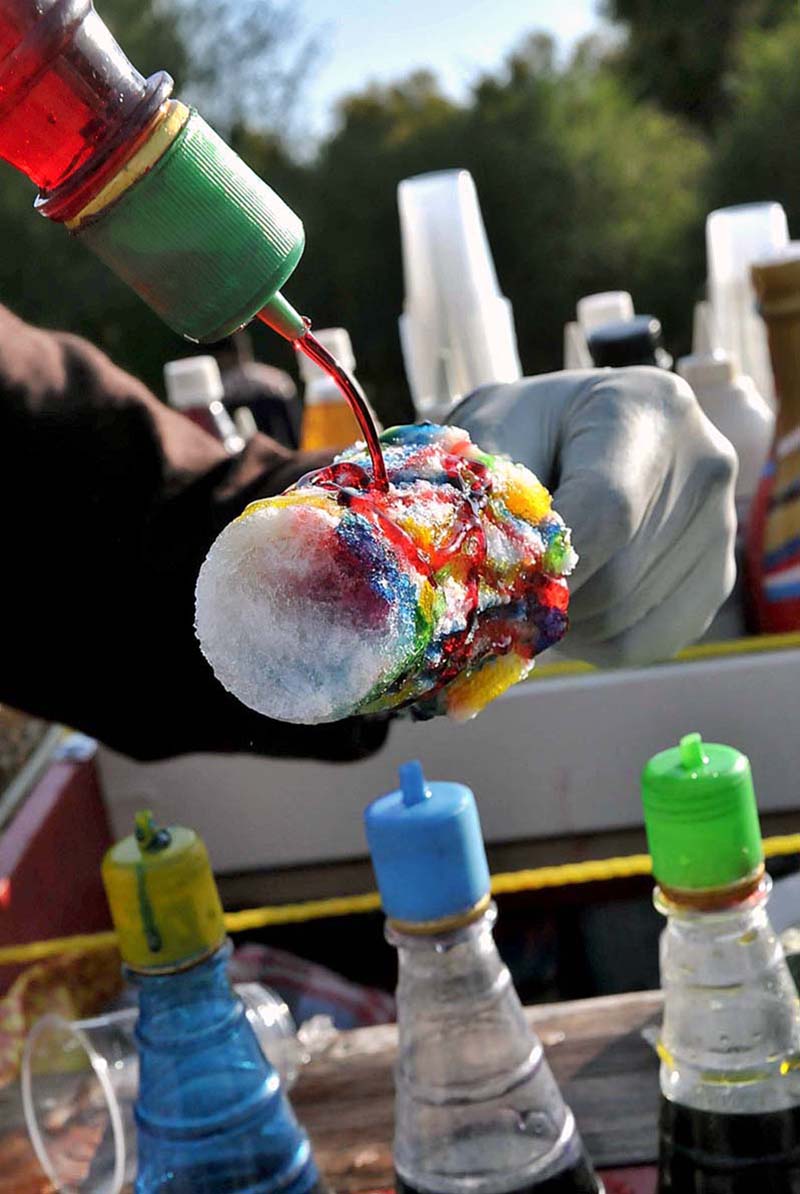 A vendor preparing ice lolly for customers in Federal Capital