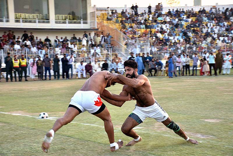 Players of Pakistan White and Pakistan Green Kabaddi teams in action in a Kabaddi Takra at Iqbal Stadium in connection with Jashan-e-Baharan celebrations organized by the district administration