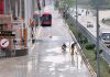 Metro Bus staff wiping out rain water at Faiz Ahmad Faiz Station