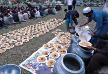 Volunteers arranging food for iftar to be distributed among the people at PIMS during Holy month of Ramzan.