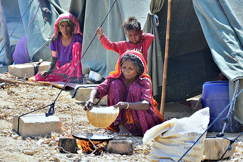 A nomad woman busy in making chapatti outside her tent at Kohsar area in the city