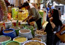 A shopkeeper is selling Masalsa jata used in food items at Delhi Darwaza Bazar