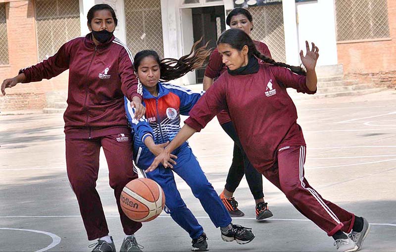 Basketball women players in action during a match played between Punjab College and Aminent College at inter-collegiate basketball tournament organized by Sargodha Board