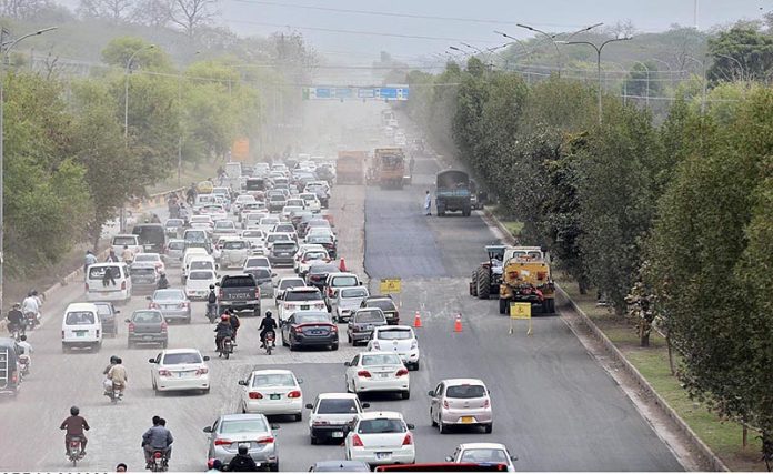 A view of heavy machinery being used for repairing and maintenance work of Expressway.