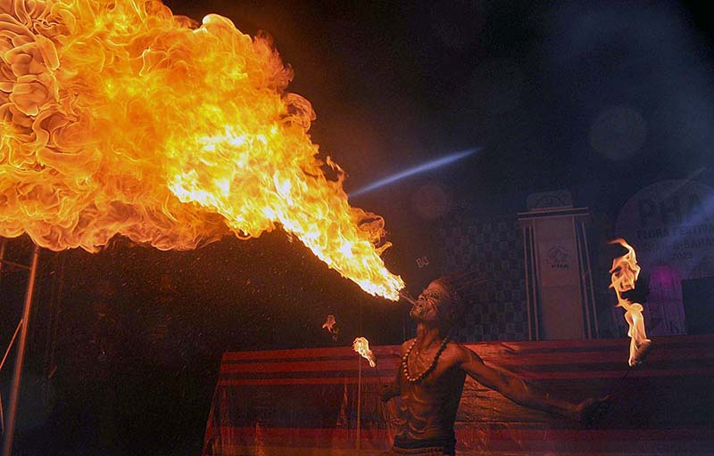 An artist performing fire breathing at Flora Festival