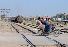 Dangerous moment as a motorcyclists crossing railway track while the train is approaching at Tando Yousaf railway crossing