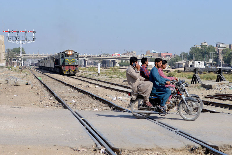 Dangerous moment as a motorcyclists crossing railway track while the train is approaching at Tando Yousaf railway crossing