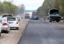A view of heavy machinery being used for repairing and maintenance work of Expressway.