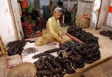 A workers busy in sorting and packing bangles at their workplace in Bangles Market