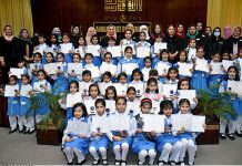 Position holder students pose for group photo with Principal Prof Alia Durrani at annual prize distribution ceremony.