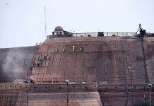Construction worker busy in renovation work on the wall of the historical Qila Balasar Fortl