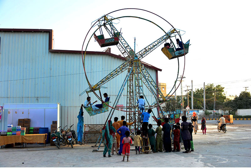 Children are enjoying the swing at Latifabad