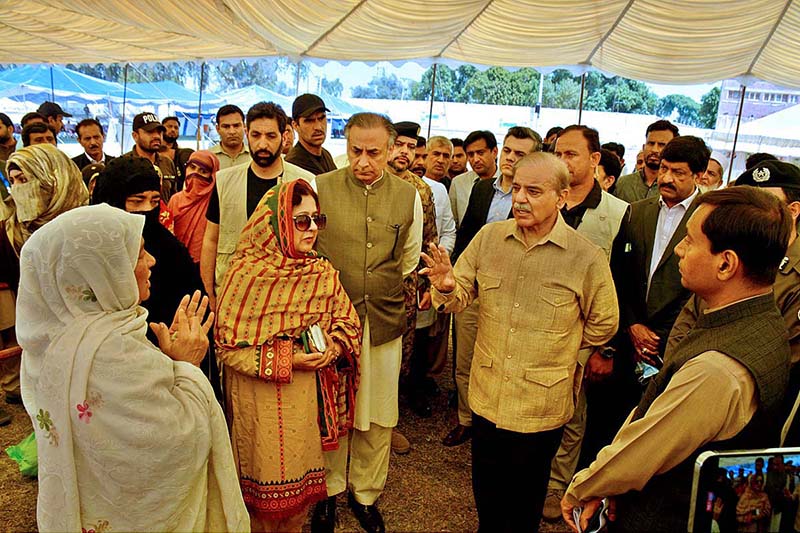 Prime Minister Muhammad Shehbaz Sharif is talking to people at free flour distribution point set up at Bahawalpur Stadium