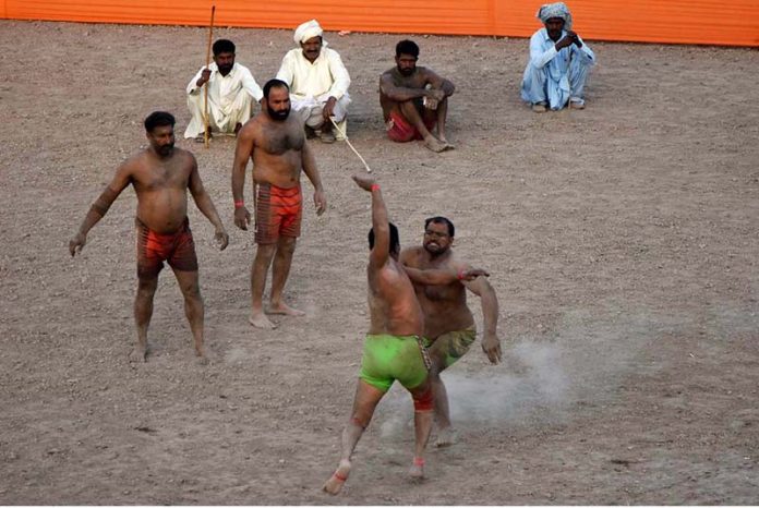 Wrestlers demonstrating their skills in Thapar Kabaddi match at Village Fareedabad