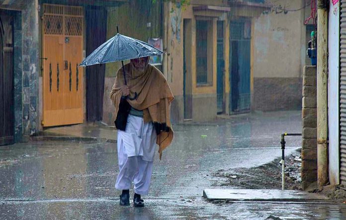 An old man covering himself with an umbrella during rain in the provincial capital