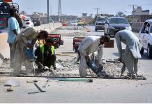 Laborers busy in repairing work of Kohat road flyover