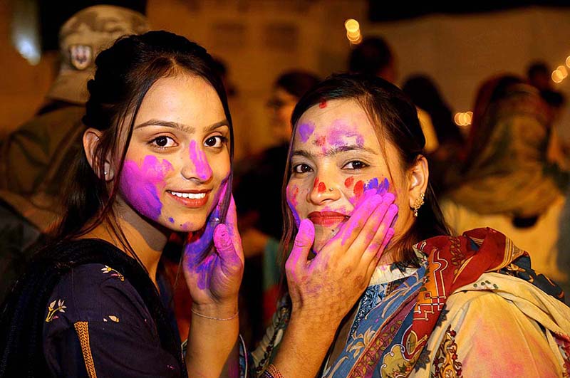 Hindu women celebrating Holi festival of colors at Durga Shiv Mandir
