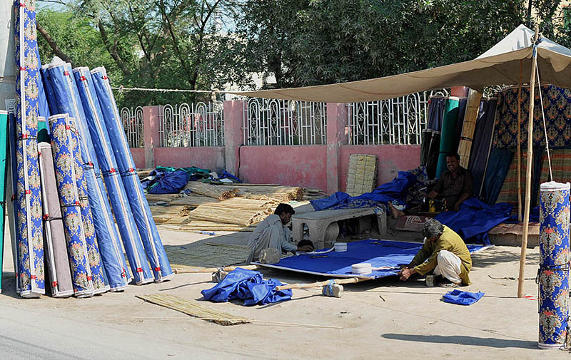 Workers busy in making traditional bamboo chick blinds at their workplace on roadside