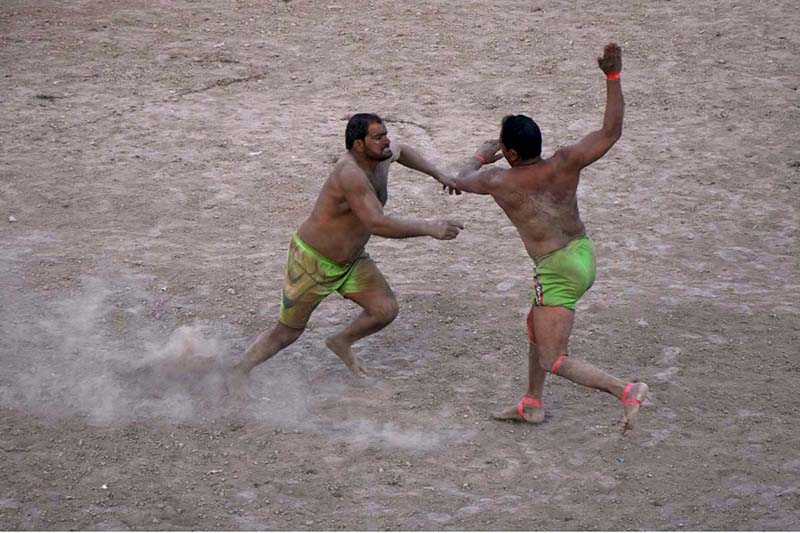 Wrestlers demonstrating their skills in Thapar Kabaddi match at Village Fareedabad