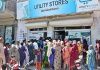 People standing in a queue waiting their turn outside Utility Store to purchase grocery items on subsidized rates in Qasimabad