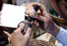 Workers giving final touches to bangles at their workplace at bangle market