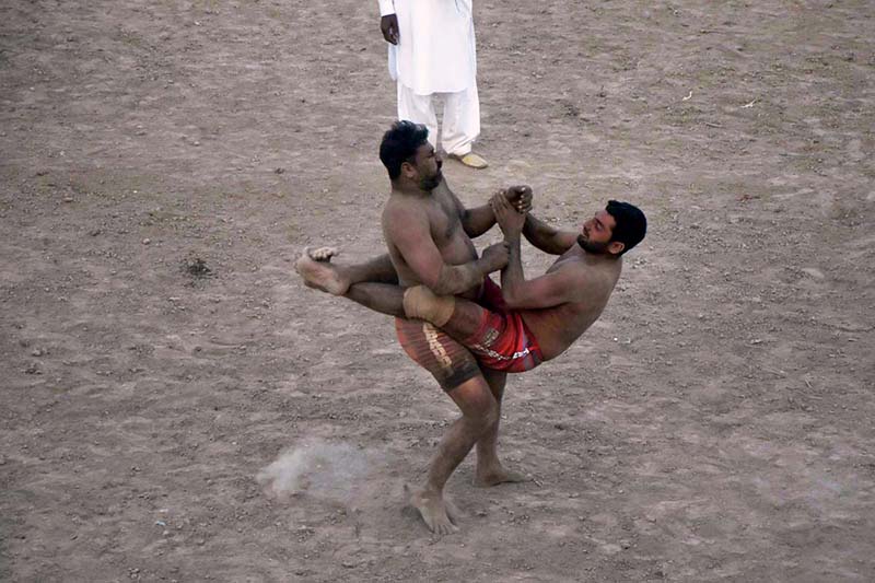 Wrestlers demonstrating their skills in Thapar Kabaddi match at Village Fareedabad