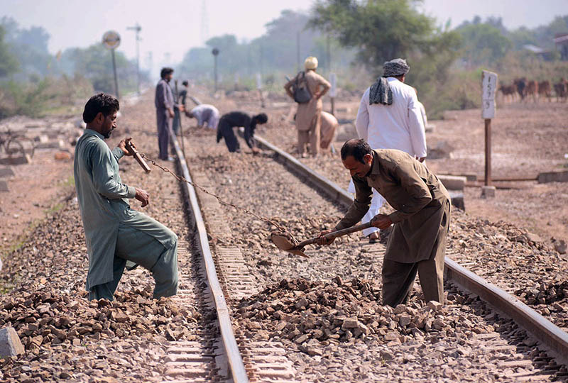 Railway staffers busy in maintenance work of railway tracks