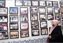 A woman visitor keenly viewing photo exhibition of PPP MNA late Ayaz Soomro 5th death anniversary at Arts Council