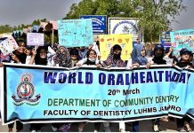 Students are participants in an awareness walk in connection with World Oral Health Day by department of Community Dentistry Faculty of Dentistry LUMHS