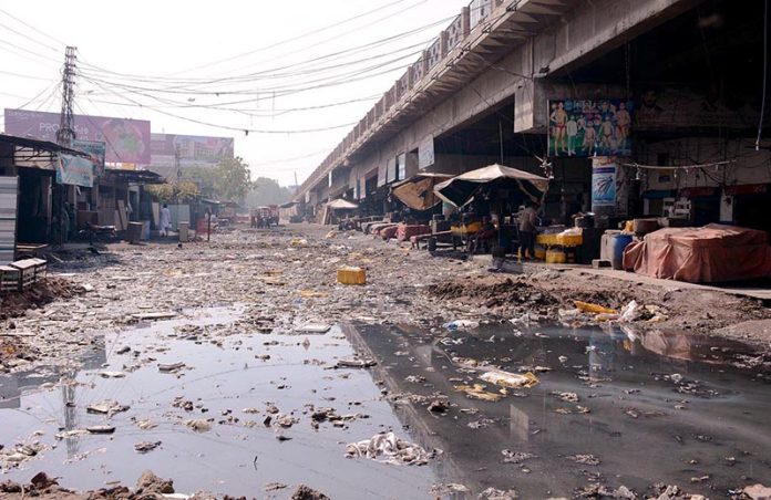 A view of garbage and sewerage water accumulated at Novelty Bridge near Fish Market creating environment problems and needs the attention of concerned authorities