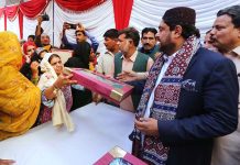 Governor Sindh Kamran Tessori distributing gifts to poor families on the occasion of 771st Urs celebration of Hazrat lal Shahbaz Qalandar