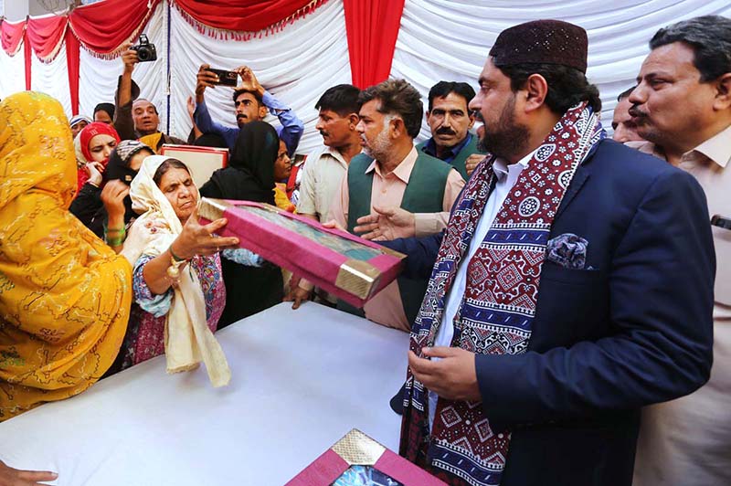 Governor Sindh Kamran Tessori distributing gifts to poor families on the occasion of 771st Urs celebration of Hazrat lal Shahbaz Qalandar