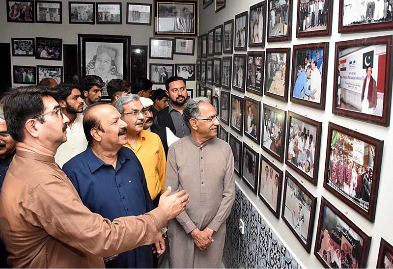 A woman visitor keenly viewing photo exhibition of PPP MNA late Ayaz Soomro 5th death anniversary at Arts Council