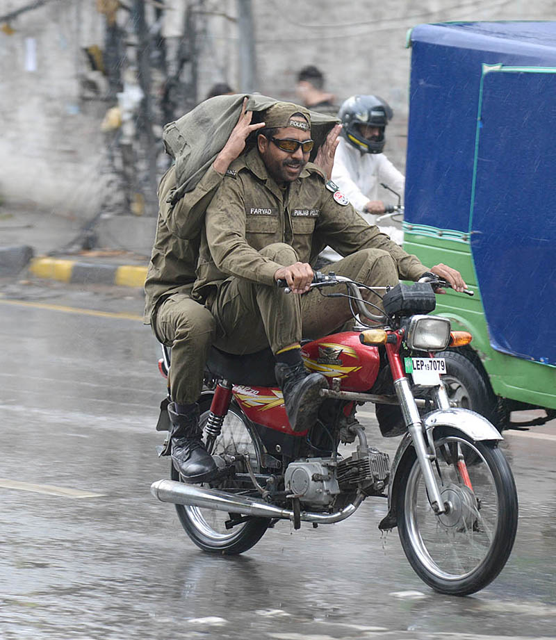 Police officials traveling during heavy rainfall in the city
