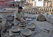 A craftsmen preparing clay made items at his workplace at Kumharpara