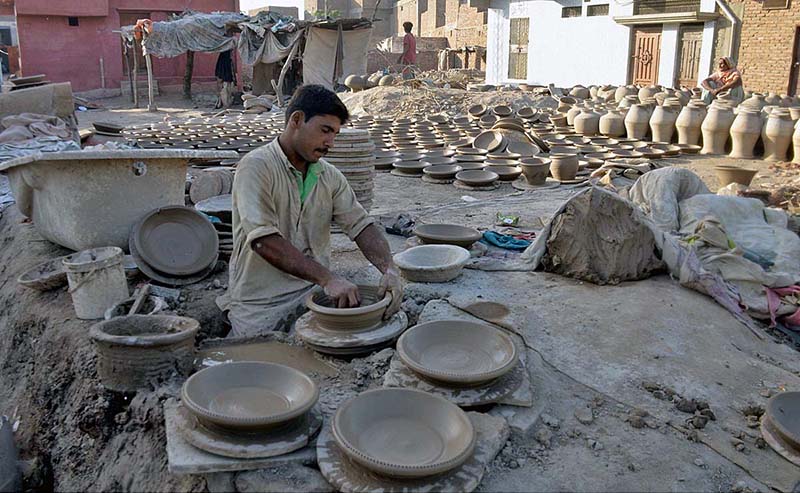 A craftsmen preparing clay made items at his workplace at Kumharpara