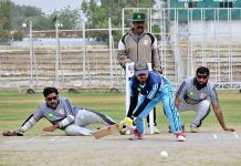 Blind cricket players in action during PAB National blind cricket tournament match between Punjab and Baluchistan teams at Niaz cricket stadium