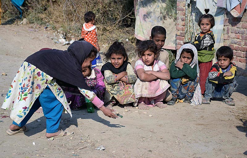 Children playing glass ball game at Hussenabad Area