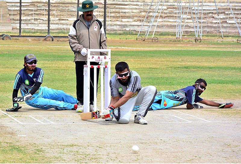 Blind cricket players in action during PAB National blind cricket tournament match between Punjab and Baluchistan teams at Niaz cricket stadium