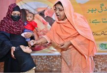 A lady health worker is administering Polio vaccine to a child during Polio free Pakistan Campaign fight to end the crippling poliovirus at Bhitai Hospital