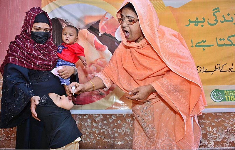 A lady health worker is administering Polio vaccine to a child during Polio free Pakistan Campaign fight to end the crippling poliovirus at Bhitai Hospital